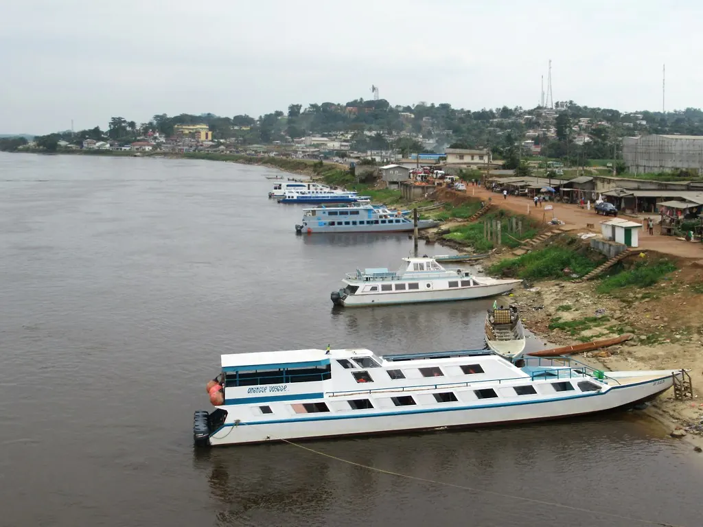 Passenger boats moored along a bank of the Ogooué river